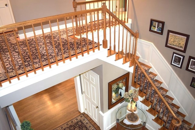 1820 Milk St, Dighton, MA 02715 - stairs with a decorative wall, wainscoting, and wood finished floors