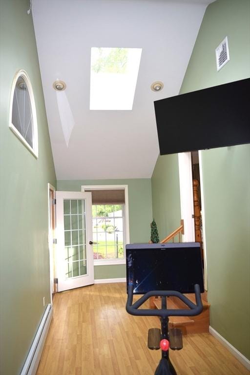 1820 Milk St, Dighton, MA 02715 - workout area with lofted ceiling, a baseboard radiator, a skylight, wood finished floors, and baseboards