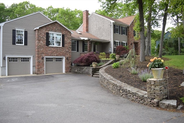 1820 Milk St, Dighton, MA 02715 - colonial inspired home with driveway, a garage, a chimney, and brick siding