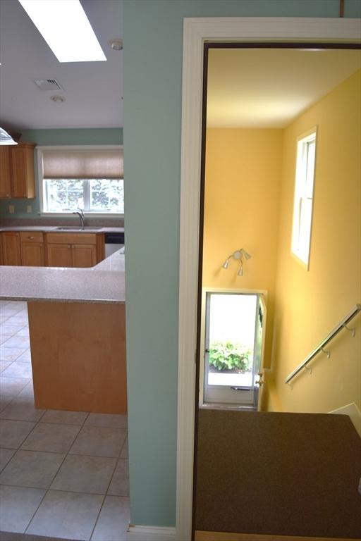 1820 Milk St, Dighton, MA 02715 - staircase featuring healthy amount of natural light, tile patterned flooring, and a skylight