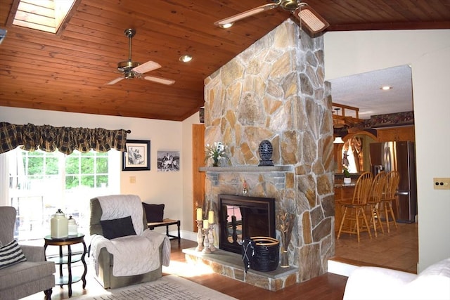 1820 Milk St, Dighton, MA 02715 - living room with a ceiling fan, wood ceiling, lofted ceiling, wood finished floors, and a stone fireplace