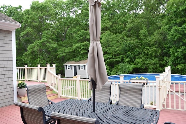 1820 Milk St, Dighton, MA 02715 - wooden terrace with outdoor dining area and an outdoor pool