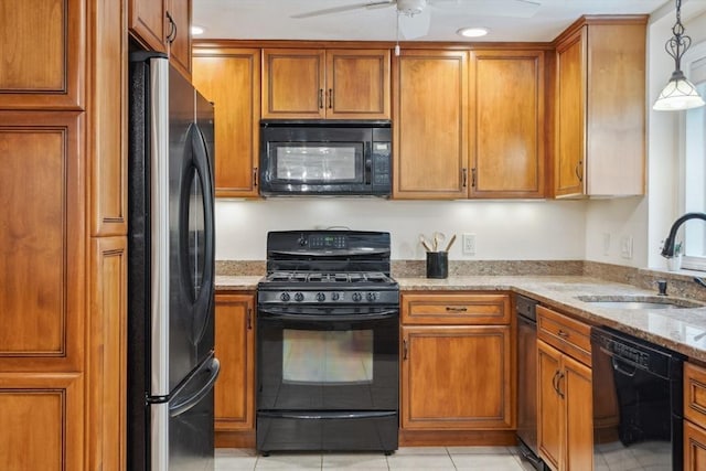 35 Michael Way Unit 29, Andover, MA 01810 - kitchen with black appliances, brown cabinetry, light tile patterned floors, light stone countertops, and a ceiling fan