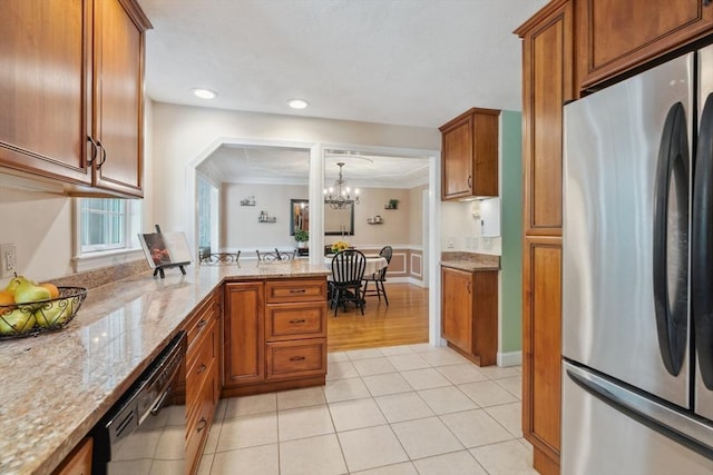 35 Michael Way Unit 29, Andover, MA 01810 - kitchen with freestanding refrigerator, black dishwasher, brown cabinets, light stone countertops, and ornamental molding