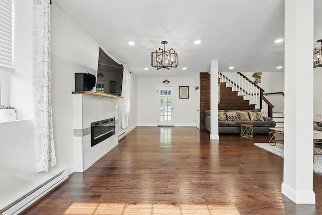 399 N Main St, Salem, NH 03079 - foyer featuring a baseboard heating unit, a glass covered fireplace, stairs, dark wood finished floors, and recessed lighting