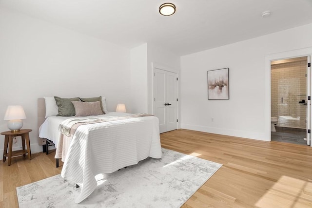 bedroom featuring wood-type flooring and ensuite bathroom