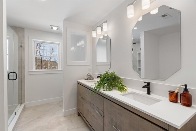 bathroom with vanity and a shower with shower door