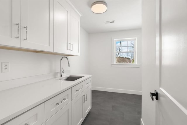 kitchen with white cabinetry and sink