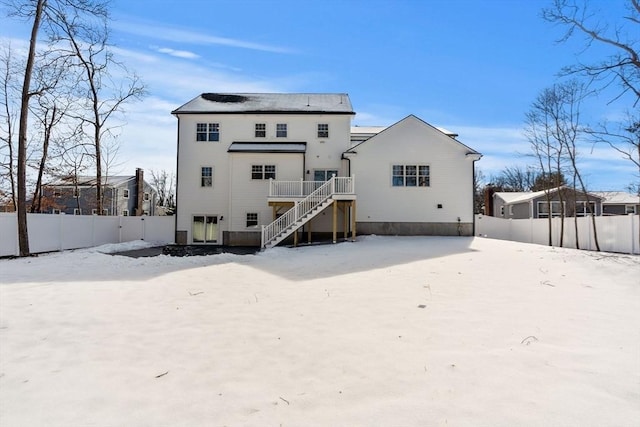 snow covered property featuring a deck