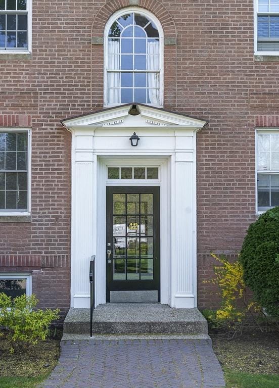 property entrance featuring brick siding