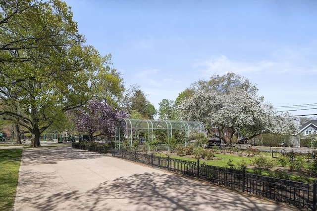 view of home's community featuring fence