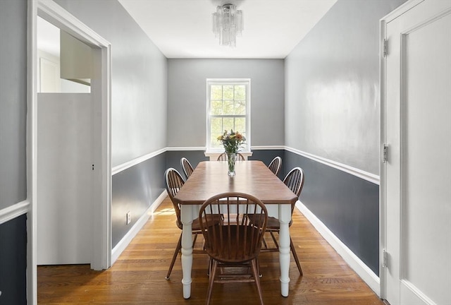 dining room featuring baseboards and wood finished floors