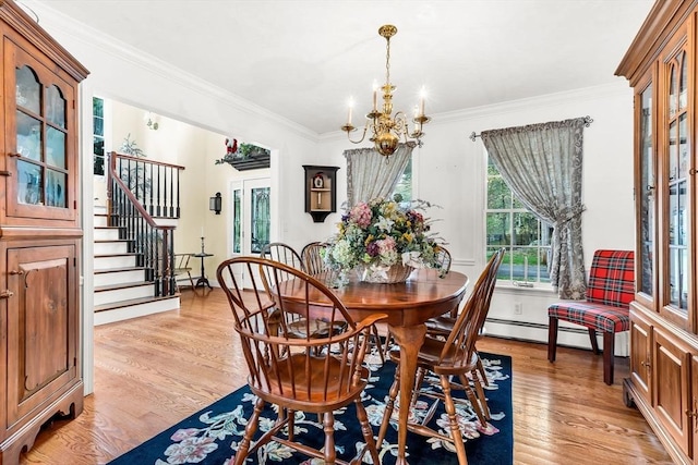 dining room with a chandelier, light wood-style floors, stairway, crown molding, and baseboard heating