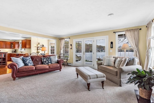 living room featuring baseboard heating, light carpet, ornamental molding, french doors, and a water view