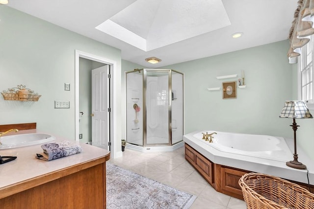 full bathroom featuring a skylight, a shower stall, vanity, a whirlpool tub, and recessed lighting