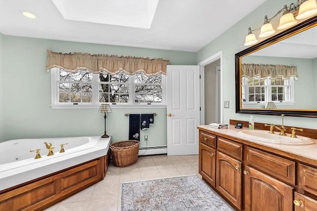 bathroom with a baseboard radiator, a skylight, a garden tub, vanity, and tile patterned flooring
