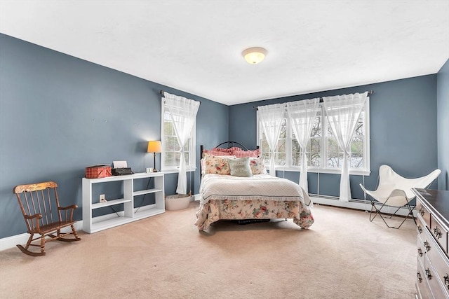 bedroom with carpet floors, a baseboard heating unit, and baseboards