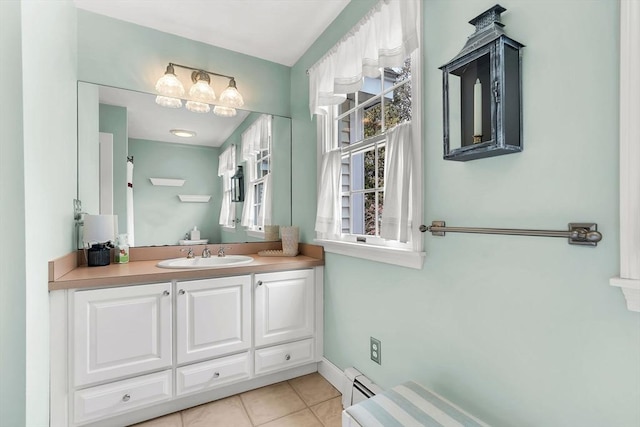 bathroom with a baseboard heating unit, vanity, and tile patterned flooring