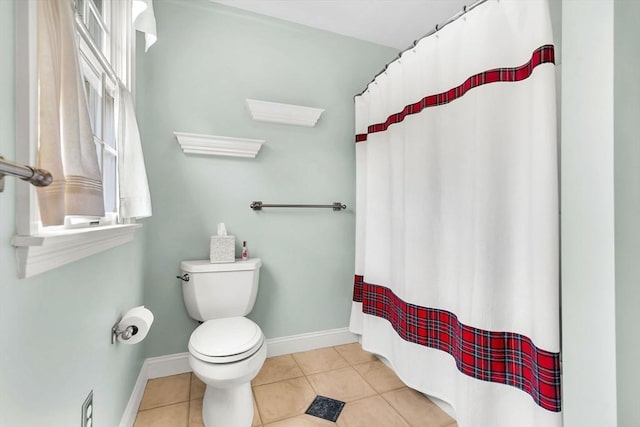 full bathroom featuring tile patterned flooring, toilet, baseboards, and curtained shower