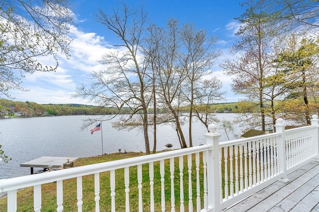 wooden terrace featuring a water view