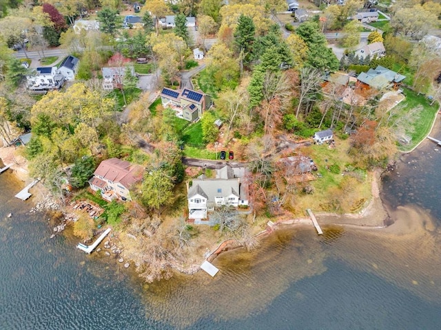 aerial view of property and surrounding area with a nearby body of water and nearby suburban area