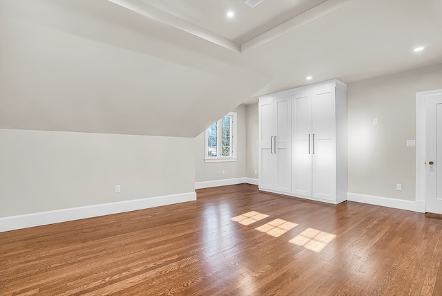 bonus room featuring hardwood / wood-style flooring and vaulted ceiling