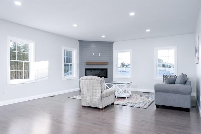 living room with a fireplace, baseboards, dark wood-style flooring, and recessed lighting