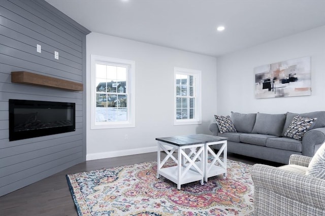 living area featuring dark wood-style floors, recessed lighting, a fireplace, and baseboards