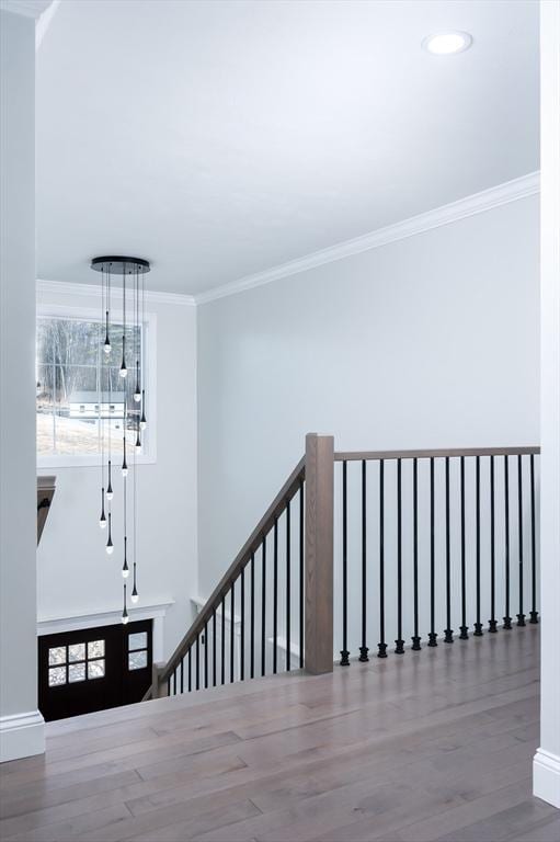 stairway with recessed lighting, baseboards, crown molding, and wood finished floors