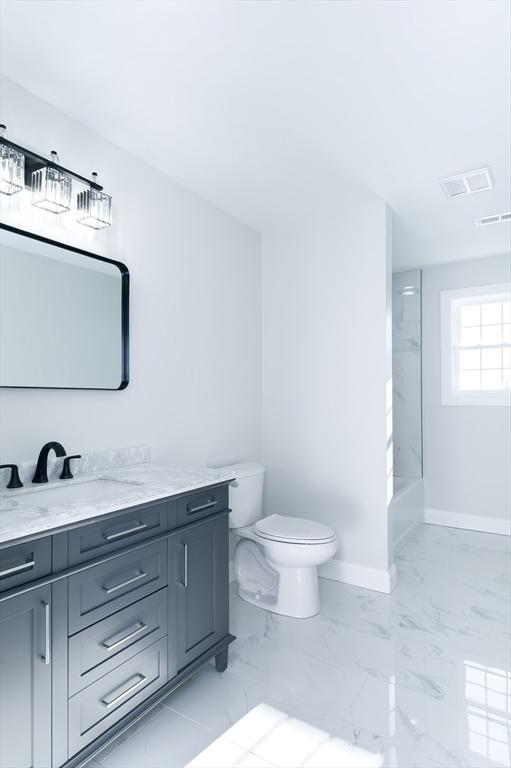 bathroom featuring marble finish floor, vanity, toilet, and baseboards