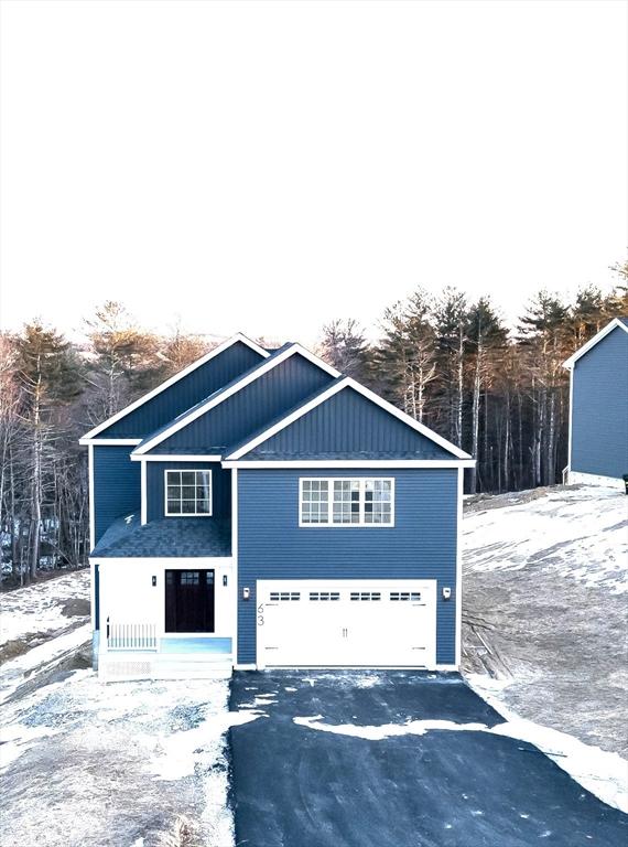 view of front facade with driveway and an attached garage