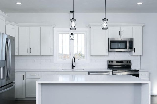 kitchen featuring stainless steel appliances, light countertops, a sink, and tasteful backsplash