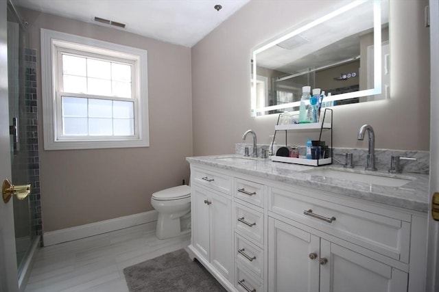 full bathroom featuring double vanity, visible vents, a stall shower, and a sink