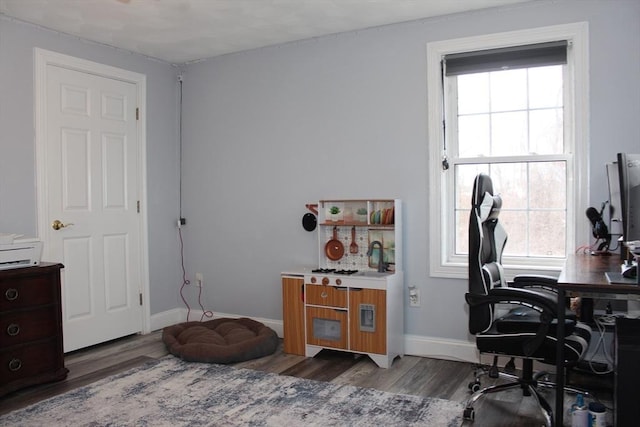 office with plenty of natural light, wood finished floors, and baseboards