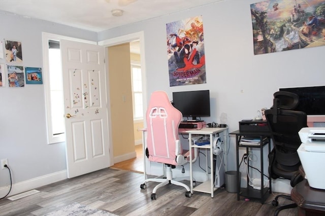 home office featuring baseboards and wood finished floors