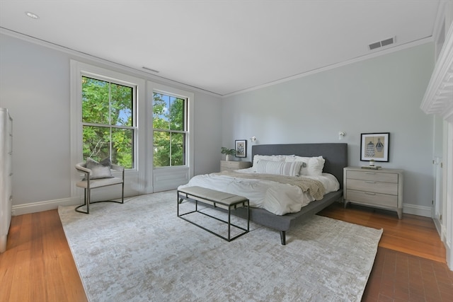 bedroom featuring dark wood-type flooring and crown molding