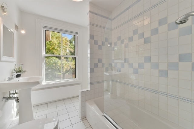 bathroom featuring tiled shower / bath and tile patterned flooring