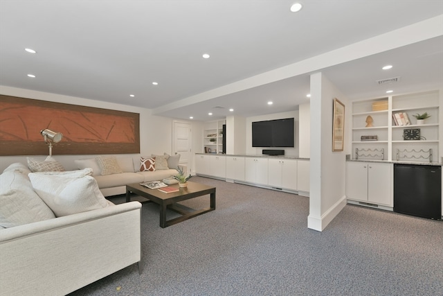 living room with carpet flooring and built in shelves