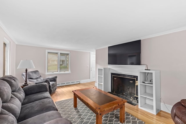 living room with wood-type flooring, a baseboard radiator, and crown molding