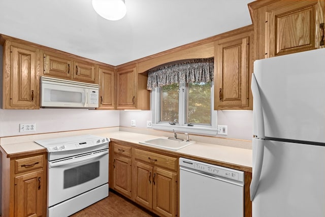 kitchen featuring white appliances and sink