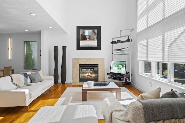 26 Sherwood Rd, Swampscott, MA 01907 - living room with wood finished floors, a high end fireplace, recessed lighting, baseboards, and a high ceiling