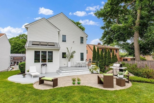 26 Sherwood Rd, Swampscott, MA 01907 - back of property featuring a patio, a wooden deck, and roof mounted solar panels