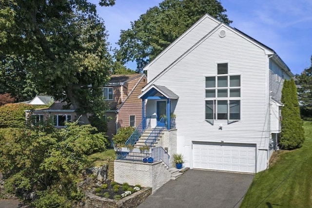 26 Sherwood Rd, Swampscott, MA 01907 - view of front of property with driveway and a garage