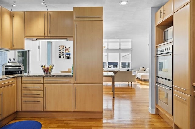 26 Sherwood Rd, Swampscott, MA 01907 - kitchen featuring light wood-style flooring, stone counters, stainless steel double oven, decorative backsplash, and recessed lighting