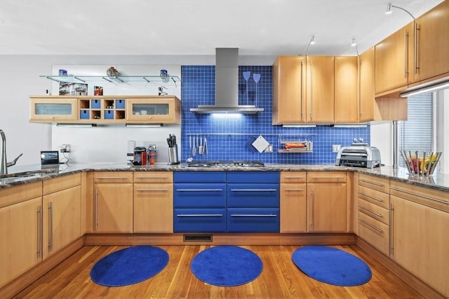 26 Sherwood Rd, Swampscott, MA 01907 - kitchen with wall chimney range hood, light wood finished floors, dark stone countertops, and stainless steel gas stovetop