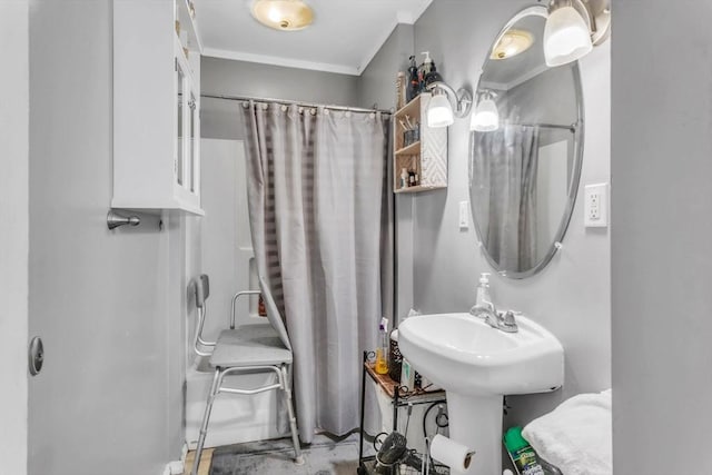 bathroom featuring crown molding and walk in shower