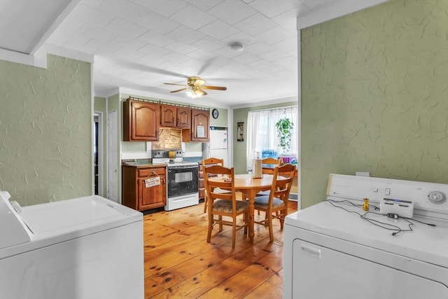 kitchen with ceiling fan, white appliances, and light hardwood / wood-style flooring