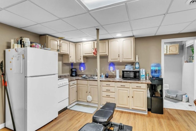 kitchen with white appliances, light hardwood / wood-style flooring, and light brown cabinets