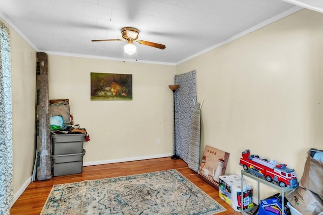 interior space featuring hardwood / wood-style flooring, ceiling fan, and ornamental molding