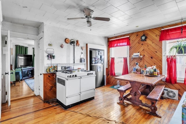 kitchen featuring ceiling fan, double oven range, and light hardwood / wood-style flooring